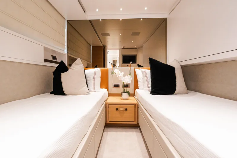 Slide: The Image of Luxurious twin cabin interior on 2021 Sanlorenzo SL96 yacht, featuring elegant decor and plush bedding. - 29