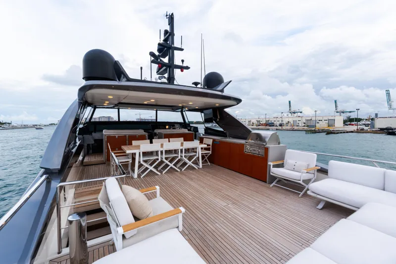 Slide: The Image of Luxurious 2021 Sanlorenzo SL96 yacht deck with seating and dining area, docked at a marina. - 46