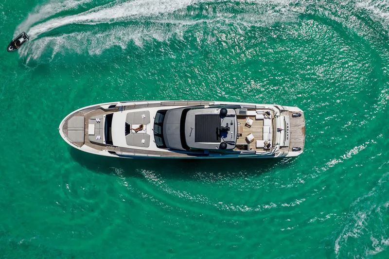 Slide: The Image of Aerial view of 2021 Sanlorenzo SL96 yacht on turquoise water with jet ski nearby. - 59