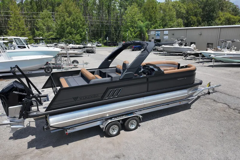 Slide: The Image of 2026 Viaggio Diamante 24 S pontoon boat on trailer in marina setting. - 2