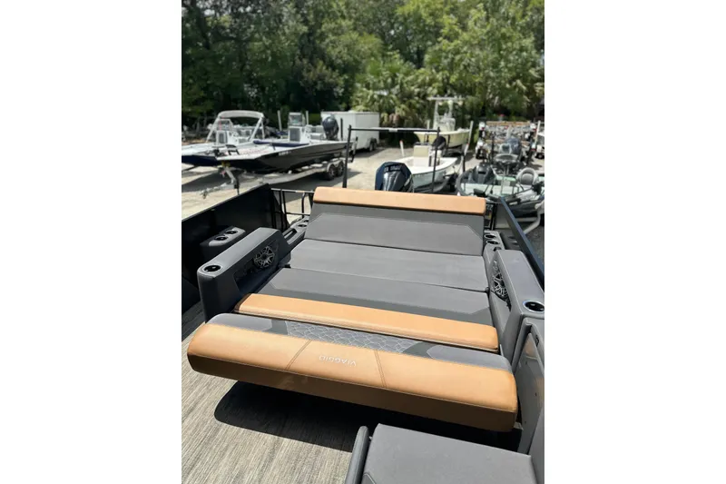 Slide: The Image of 2026 Viaggio Diamante 24 S boat with luxurious seating, docked among other boats. - 26