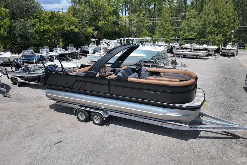 Slide: The Image of 2026 Viaggio Diamante 24 S pontoon boat on trailer in a marina setting. - 3