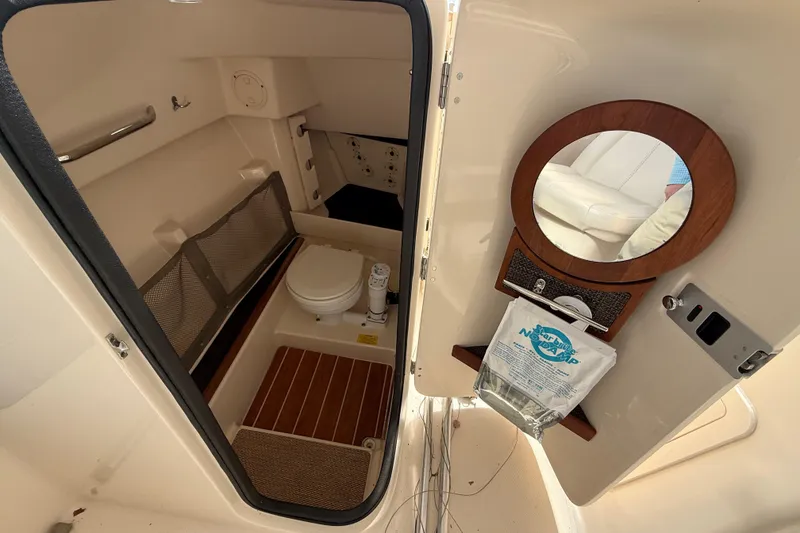 Slide: The Image of 2015 Grady-White Freedom 285 boat interior with toilet and mirror. - 10