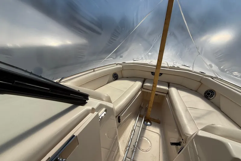 Slide: The Image of 2015 Grady-White Freedom 285 boat interior with beige seating and protective cover. - 12