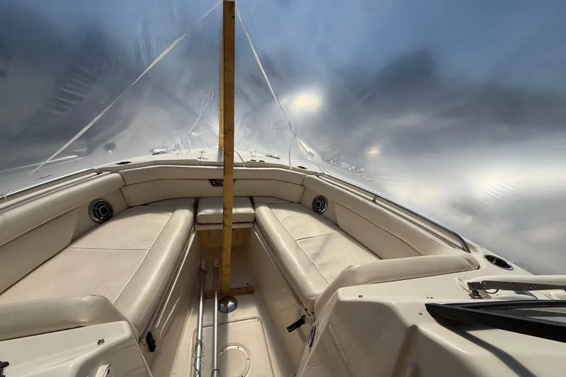 Slide: The Image of 2015 Grady-White Freedom 285 boat interior with beige seating and protective cover. - 13