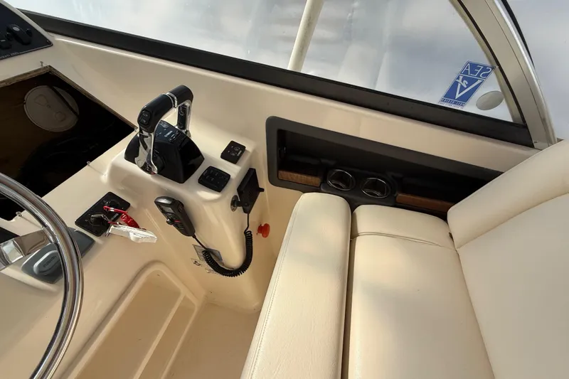 Slide: The Image of Interior view of 2015 Grady-White Freedom 285 boat cockpit with controls and seating. - 17