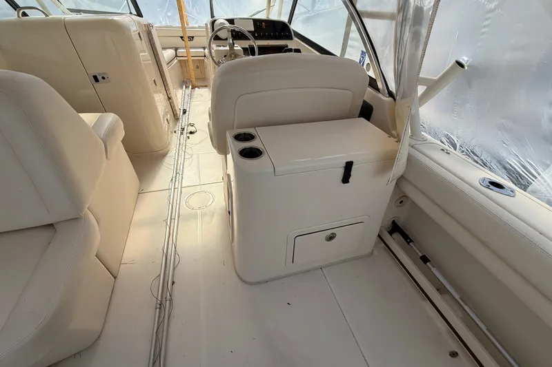 Slide: The Image of 2015 Grady-White Freedom 285 boat interior with white seating and steering console. - 19