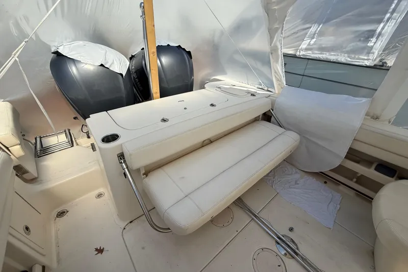 Slide: The Image of 2015 Grady-White Freedom 285 boat interior with dual engines and seating area. - 21