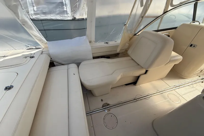 Slide: The Image of Interior of a 2015 Grady-White Freedom 285 boat with white seating and protective covers. - 22