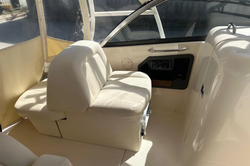 Slide: The Image of 2015 Grady-White Freedom 285 boat interior with beige seating and control panel. - 5