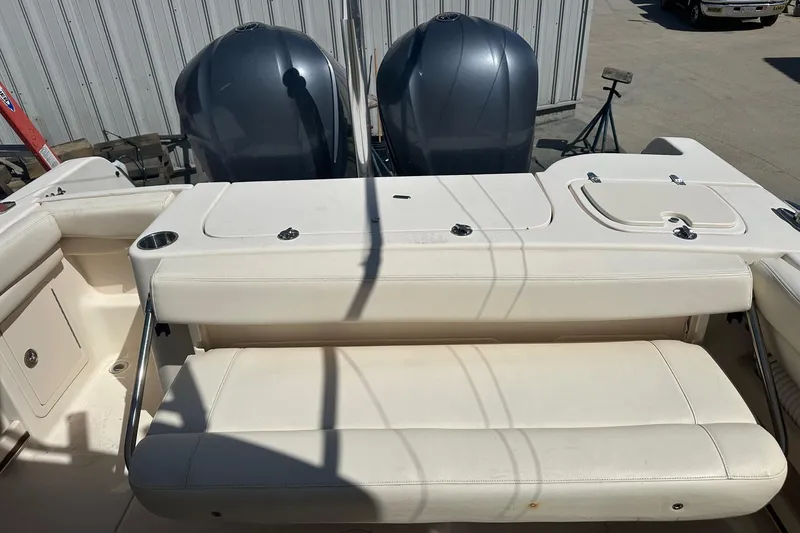 Slide: The Image of 2015 Grady-White Freedom 285 boat interior with dual engines and seating area. - 6