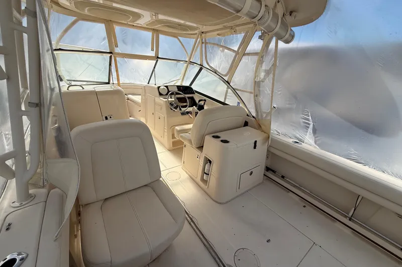 Slide: The Image of 2015 Grady-White Freedom 285 boat interior with beige seating and helm station. - 8