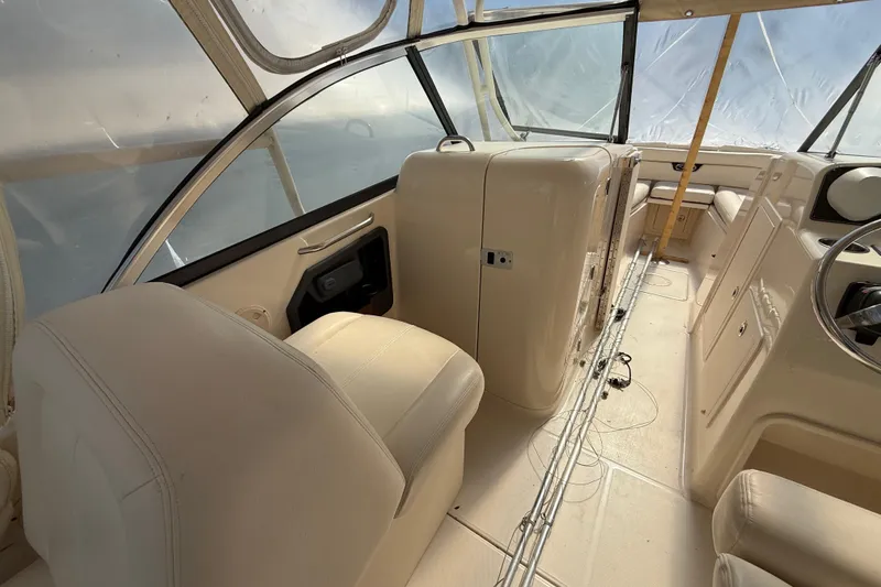 Slide: The Image of Interior of 2015 Grady-White Freedom 285 boat, featuring seating and helm area. - 9