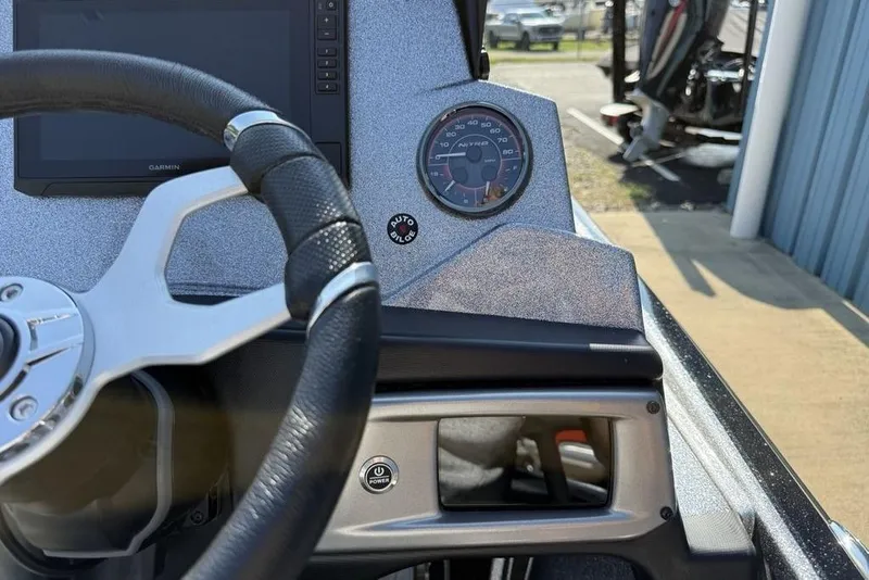 Slide: The Image of Steering wheel and dashboard of 2026 Nitro Z20 XL Pro boat with speedometer and Garmin display. - 13