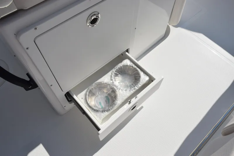 Slide: The Image of Open storage drawer on 2026 Sea Hunt Ultra 275 SE boat, containing wrapped items. - 18