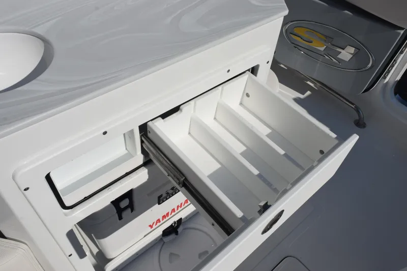 Slide: The Image of Open storage compartment on 2026 Sea Hunt Ultra 275 SE boat with Yamaha cooler. - 20