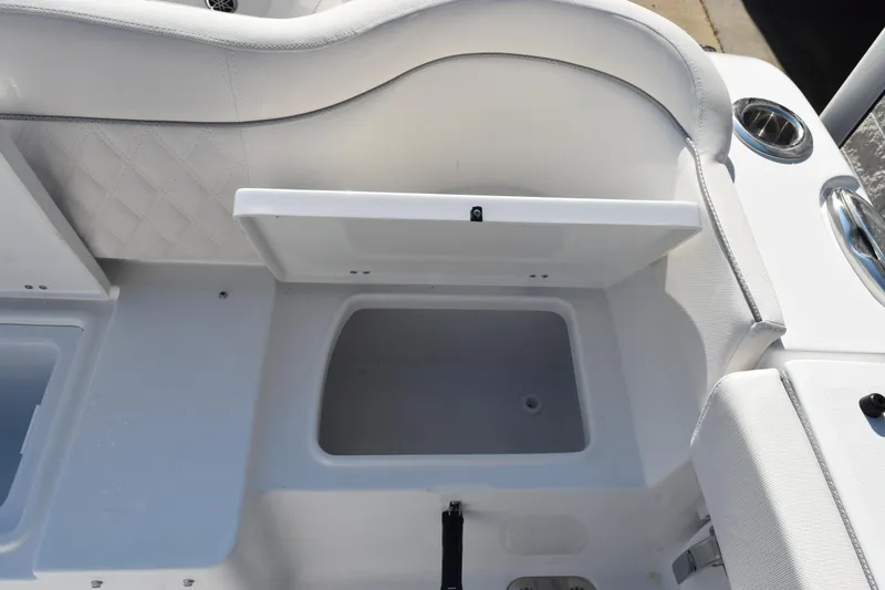 Slide: The Image of 2026 Sea Hunt Ultra 275 SE boat storage compartment with open lid, showcasing interior space. - 24
