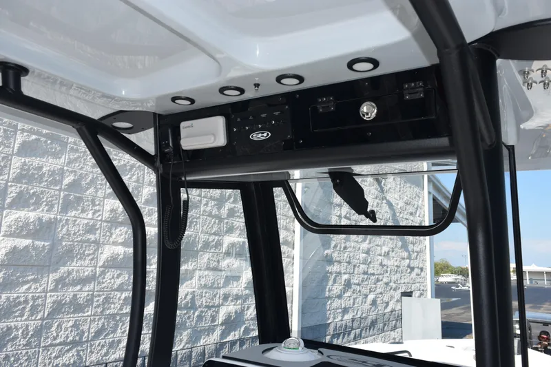 Slide: The Image of Interior view of 2026 Sea Hunt Ultra 275 SE boat's control panel and structure. - 9