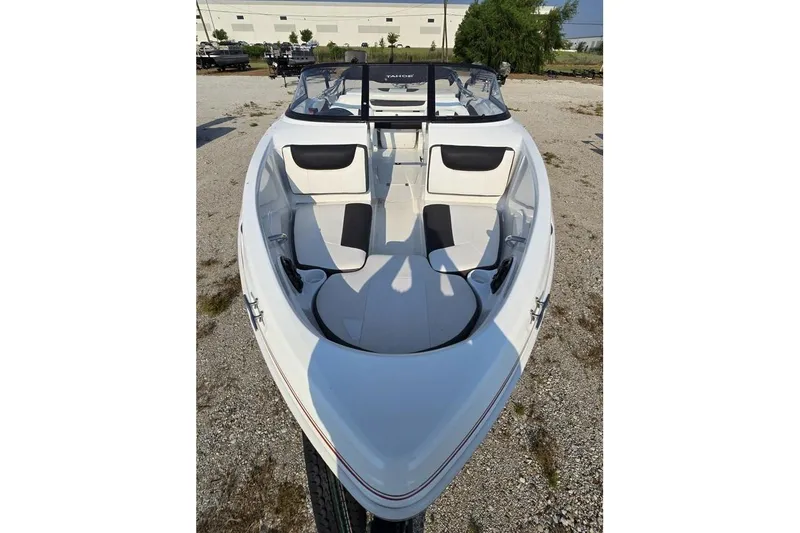 Slide: The Image of 2019 Tahoe 500 TS boat with sleek white interior and black accents, parked outdoors. - 6