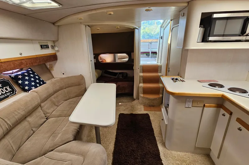 Slide: The Image of Interior of 1995 Cruisers Yachts 3775 Esprit with cozy seating and kitchenette. - 25