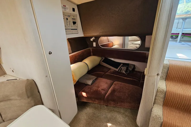 Slide: The Image of 1995 Cruisers Yachts 3775 Esprit interior cabin with brown seating and control panel. - 26
