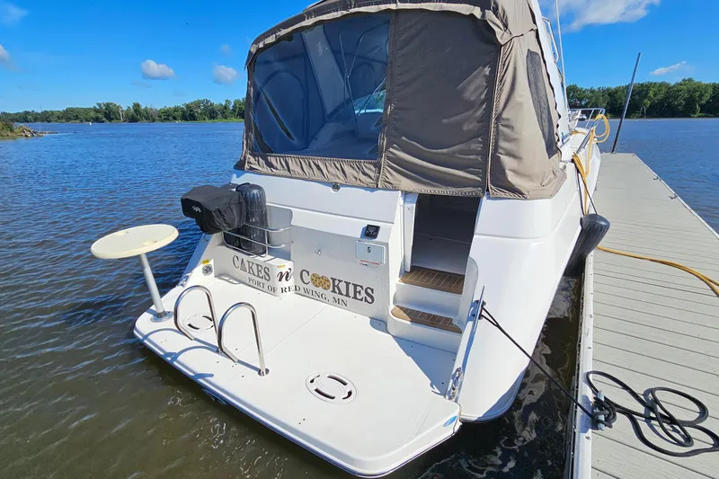 Slide: The Image of 1995 Cruisers Yachts 3775 Esprit docked on a sunny day, rear view. - 3