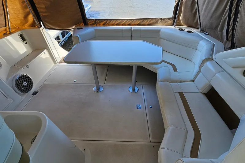 Slide: The Image of 1995 Cruisers Yachts 3775 Esprit interior with seating and table, featuring beige upholstery. - 9
