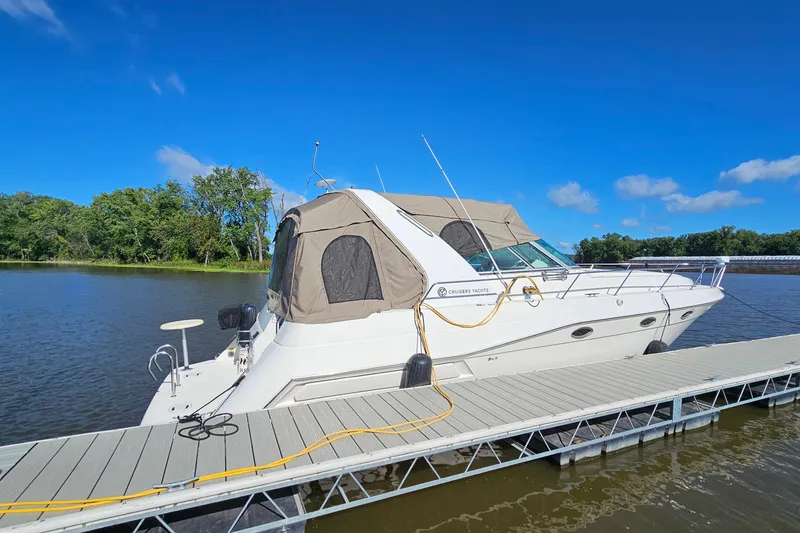 The Image of 1995 Cruisers Yachts 3775 Esprit docked on a sunny day by a river. - 1