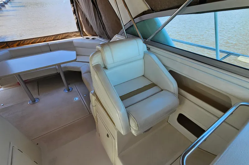 Slide: The Image of 1995 Cruisers Yachts 3775 Esprit interior with seating and table, overlooking water. - 10