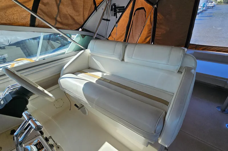 Slide: The Image of Interior of 1995 Cruisers Yachts 3775 Esprit with white seating and steering wheel. - 11