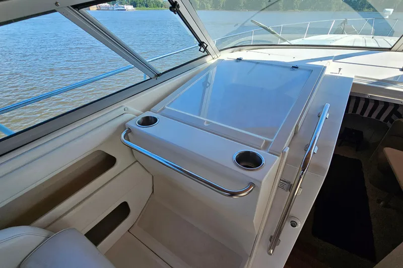 Slide: The Image of 1995 Cruisers Yachts 3775 Esprit cockpit with cup holders and water view. - 13
