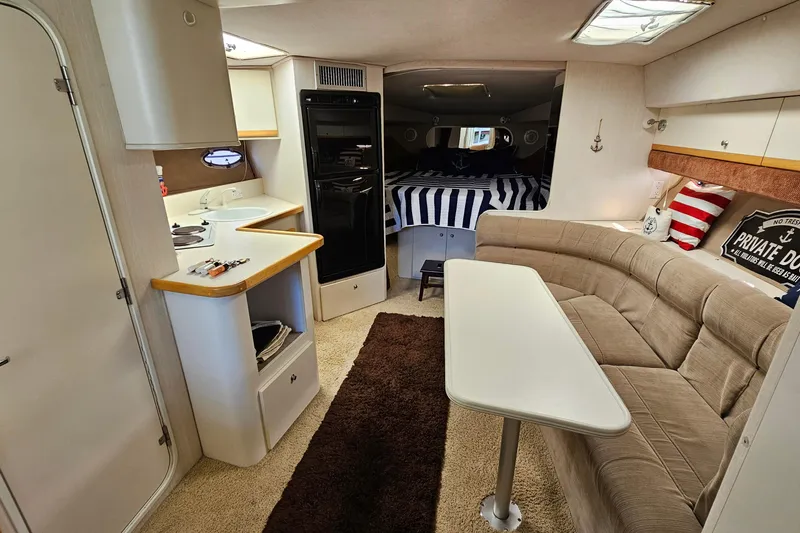 Slide: The Image of Interior of 1995 Cruisers Yachts 3775 Esprit with cozy seating and kitchenette. - 19