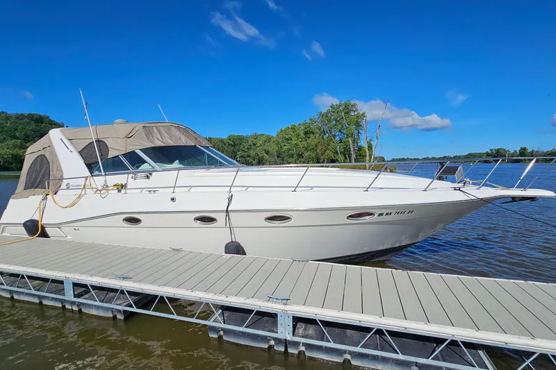 Slide: The Image of 1995 Cruisers Yachts 3775 Esprit docked on a sunny day by the lake. - 2