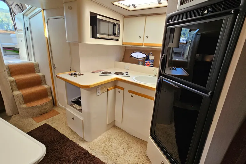 Slide: The Image of Interior of 1995 Cruisers Yachts 3775 Esprit with kitchen and stairs. - 23
