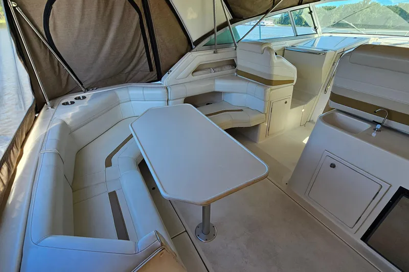 Slide: The Image of Interior of 1995 Cruisers Yachts 3775 Esprit with seating and table setup. - 6