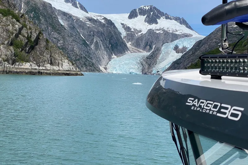 Slide: The Image of 2019 Sargo 36 Explorer boat docked in a serene, forested harbor. - 3