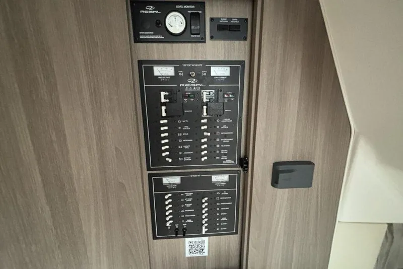 Slide: The Image of Control panel of a 2019 Regal 33 XO boat, featuring switches and gauges. - 19