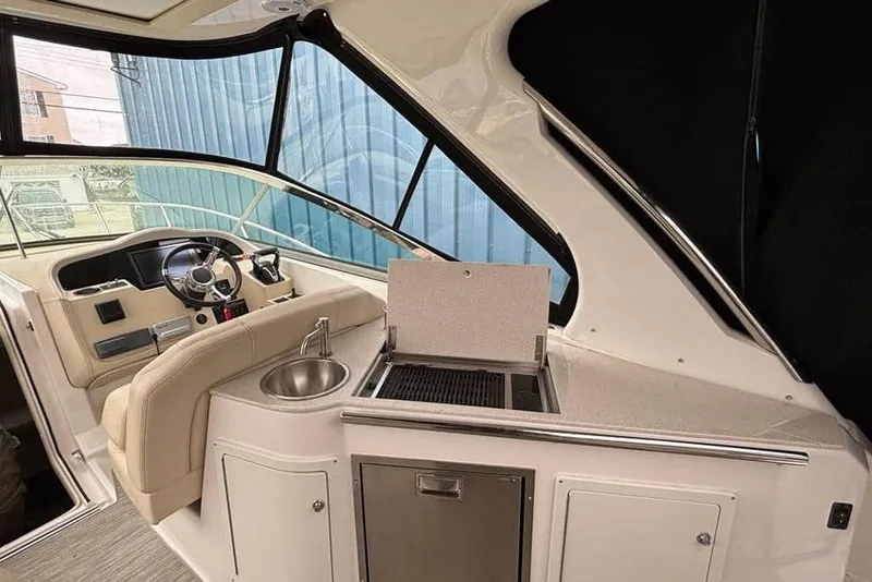 Slide: The Image of Interior of 2019 Regal 33 XO boat with helm, sink, and grill. - 3