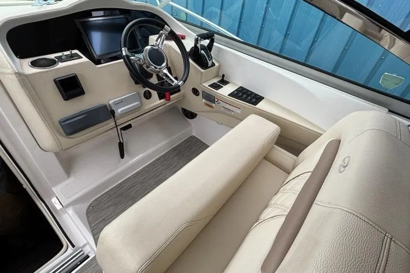 Slide: The Image of 2019 Regal 33 XO boat cockpit with modern steering and control panel. - 4