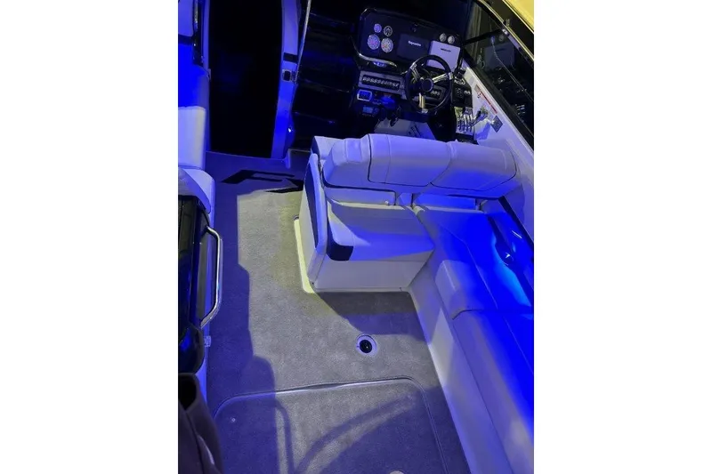 Slide: The Image of 2015 Formula 310 Sun Sport boat interior with blue ambient lighting and seating. - 11
