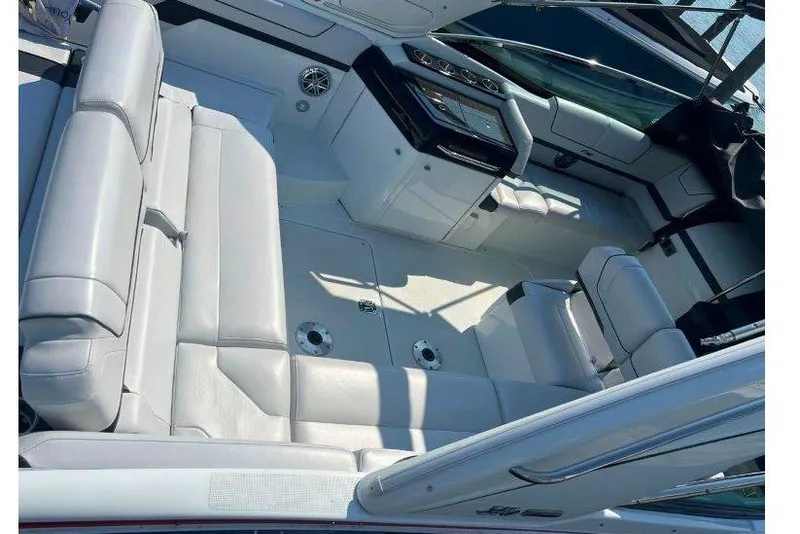 Slide: The Image of 2015 Formula 310 Sun Sport boat interior with white seating and control panel. - 12