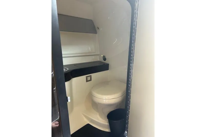 Slide: The Image of 2015 Formula 310 Sun Sport boat bathroom interior with toilet and counter. - 19