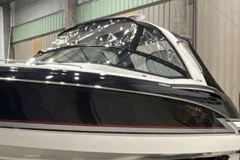Slide: The Image of 2015 Formula 310 Sun Sport boat in a showroom, featuring sleek design and glossy finish. - 2
