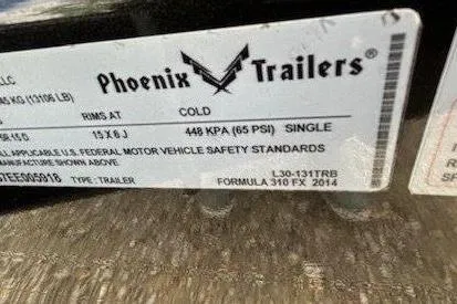 Slide: The Image of Label on Phoenix Trailers, 2015 Formula 310 Sun Sport, showing tire pressure and safety standards. - 22