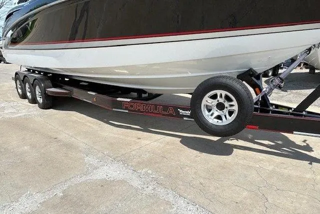 Slide: The Image of 2015 Formula 310 Sun Sport boat on a trailer, parked on concrete. - 3