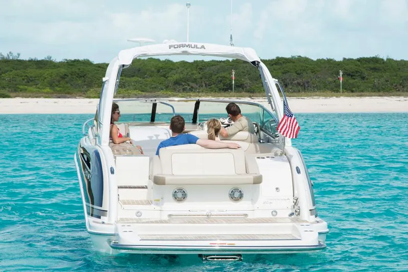 Slide: The Image of Manufacturer Provided Image: 2015 Formula 310 Sun Sport boat cruising with passengers on turquoise water. - 9