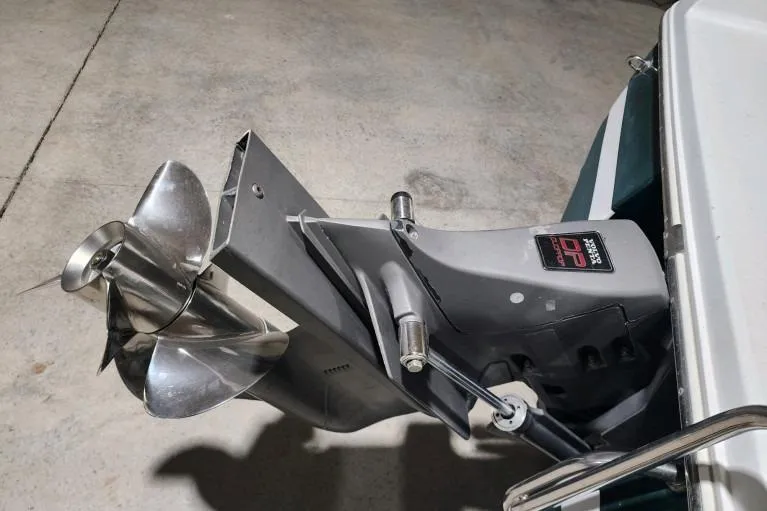 Slide: The Image of 1998 Cobalt 220 boat propeller and outdrive in a garage setting. - 14