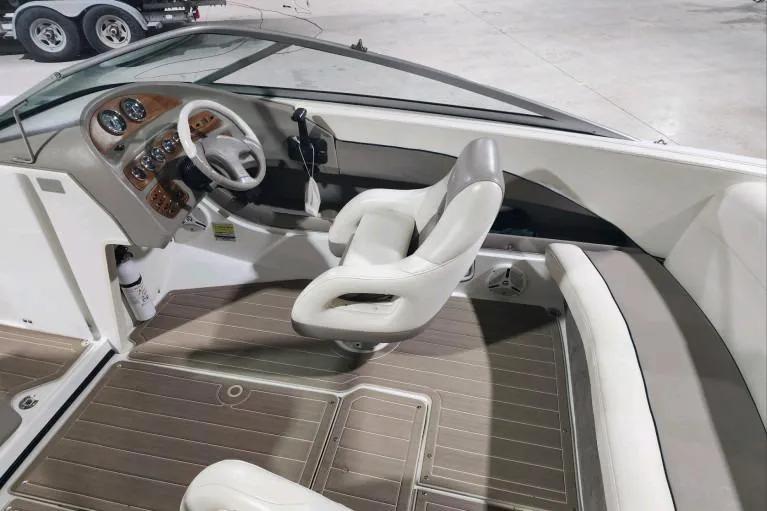 Slide: The Image of Interior of a 1998 Cobalt 220 boat with steering wheel and seating. - 6