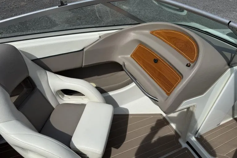 Slide: The Image of Interior of a 1998 Cobalt 220 boat with beige seating and wood accents. - 7