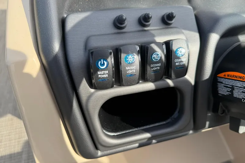 Slide: The Image of Control panel of 2026 Bentley Pontoons Legacy 223 Navigator with labeled switches. - 10